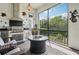 Outdoor kitchen with grill, fire pit, and screened lanai at 1029 Seagrape Dr, Ruskin, FL 33570