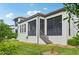 Modern house exterior with screened-in porch and landscaping at 1029 Seagrape Dr, Ruskin, FL 33570