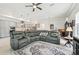 Open concept living room with a gray sectional sofa and kitchen view at 1029 Seagrape Dr, Ruskin, FL 33570