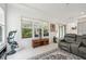 Living room with a gray sectional, large windows, and a view of the backyard at 1029 Seagrape Dr, Ruskin, FL 33570