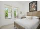 Bright bedroom with a queen bed and access to a balcony at 1029 Seagrape Dr, Ruskin, FL 33570