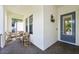 Inviting front porch with wicker chairs and a brick floor at 1029 Seagrape Dr, Ruskin, FL 33570