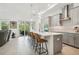 Modern kitchen with gray cabinetry and a large quartz island at 1029 Seagrape Dr, Ruskin, FL 33570