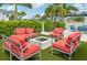 Relaxing fire pit area with red cushioned seating at 1029 Seagrape Dr, Ruskin, FL 33570