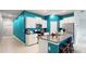 Modern kitchen with white cabinets, teal walls, and an island at 15407 Miller Creek Dr, Sun City Center, FL 33573