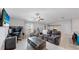 Living room with seating area and a home office setup at 15407 Miller Creek Dr, Sun City Center, FL 33573