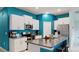 Modern kitchen with granite island and teal accents at 15407 Miller Creek Dr, Sun City Center, FL 33573