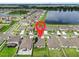 Aerial view of a residential area with highlighted home near a lake at 15407 Miller Creek Dr, Sun City Center, FL 33573
