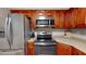 Stainless steel appliances and wood cabinets in this updated kitchen at 3866 37Th S St # 47, St Petersburg, FL 33711