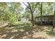 View of backyard, showing shed and spacious lawn at 10542 Helena St, New Port Richey, FL 34654