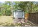 Detached storage shed with roll-up door and wooden walls at 10542 Helena St, New Port Richey, FL 34654