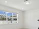 Minimalist bedroom with large window for natural light and a neutral color palette at 4285 Big Sky Dr, Spring Hill, FL 34604