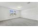 Bright bedroom with two windows offering natural light and neutral carpet at 4285 Big Sky Dr, Spring Hill, FL 34604