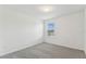 Neutral bedroom featuring plush carpet and a bright window at 4285 Big Sky Dr, Spring Hill, FL 34604