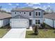 Charming two-story home with an attached two-car garage and well-maintained landscaping in a suburban neighborhood at 4285 Big Sky Dr, Spring Hill, FL 34604