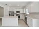 Contemporary kitchen with stainless steel appliances, white cabinets and countertop island at 4285 Big Sky Dr, Spring Hill, FL 34604