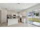 Well-lit kitchen equipped with stainless steel appliances, white cabinetry, and backyard views at 4285 Big Sky Dr, Spring Hill, FL 34604