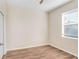 Spacious bedroom with neutral walls, wood-look floors, and a window with blinds at 200 Fairmont Dr, Spring Hill, FL 34609