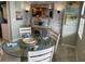 Bright dining area with glass-top table and seating for four at 445 Hamden Dr # 505, Clearwater Beach, FL 33767