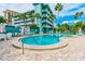 Community pool with surrounding patio furniture at 445 Hamden Dr # 505, Clearwater Beach, FL 33767