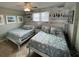 Bright guest bedroom with two twin beds and coastal decor at 445 Hamden Dr # 505, Clearwater Beach, FL 33767