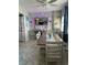 Bright dining area with a farmhouse style table and stone accent wall at 445 Hamden Dr # 505, Clearwater Beach, FL 33767
