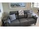 Living room with grey leather couch and coastal decor at 445 Hamden Dr # 505, Clearwater Beach, FL 33767
