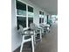 Small patio with gray chairs, providing an outdoor seating area at 445 Hamden Dr # 505, Clearwater Beach, FL 33767