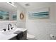 Updated bathroom with white subway tile and gray vanity at 7400 Sun Island S Dr # 407, South Pasadena, FL 33707