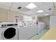 Shared laundry facility with multiple washers and dryers at 7400 Sun Island S Dr # 407, South Pasadena, FL 33707