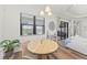 Casual dining area with round wooden table and chairs, near sliding doors at 13769 Old Creek Ct, Parrish, FL 34219