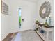 Bright and airy entryway with decorative mirror and console table at 13769 Old Creek Ct, Parrish, FL 34219