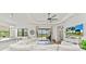 Bright living room with pool view, featuring comfortable seating and large TV at 13769 Old Creek Ct, Parrish, FL 34219