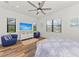 Relaxing bedroom with large TV, comfortable seating, and a queen bed at 13769 Old Creek Ct, Parrish, FL 34219