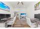 Bright home office with two workstations, hardwood floors, and a view into the kitchen at 13769 Old Creek Ct, Parrish, FL 34219