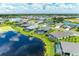 Aerial view showcasing a beautiful community by the lake with many houses at 13769 Old Creek Ct, Parrish, FL 34219