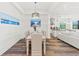 Light-filled dining room with a farmhouse table and view of the kitchen at 13769 Old Creek Ct, Parrish, FL 34219