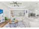 Open living room with large sectional sofa and access to kitchen at 13769 Old Creek Ct, Parrish, FL 34219