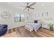 Spacious bedroom with ceiling fan, large window, and comfortable seating at 13769 Old Creek Ct, Parrish, FL 34219