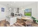 Modern kitchen with island, stainless steel appliances, and breakfast nook at 13769 Old Creek Ct, Parrish, FL 34219