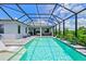 Stunning pool area with covered patio, lounge chairs, and lush landscaping at 13769 Old Creek Ct, Parrish, FL 34219