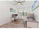 Bright home office with two desks, window, and wood floor at 13769 Old Creek Ct, Parrish, FL 34219