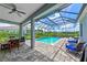 Inviting pool area with covered patio, seating, and beautiful landscaping at 13769 Old Creek Ct, Parrish, FL 34219