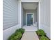 Covered entryway with gray door and white bench at 13769 Old Creek Ct, Parrish, FL 34219