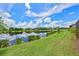 Scenic pond view with lush landscaping and reflection of homes at 13769 Old Creek Ct, Parrish, FL 34219
