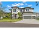 Two-story home with modern facade and a gray driveway at 5025 W Dante Ave, Tampa, FL 33629