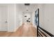 Long hallway with light hardwood floors and access to bedrooms at 5025 W Dante Ave, Tampa, FL 33629