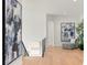 Spacious hallway with light hardwood floors and modern art at 5025 W Dante Ave, Tampa, FL 33629