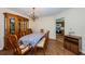 Dining area with a wood china cabinet, a long table with chairs, and tile flooring at 11705 66Th N Ave, Seminole, FL 33772