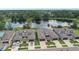 Aerial view of luxury homes overlooking a tranquil lake with lush greenery surrounding the community at 281 Villa Corte Dr, Lutz, FL 33549